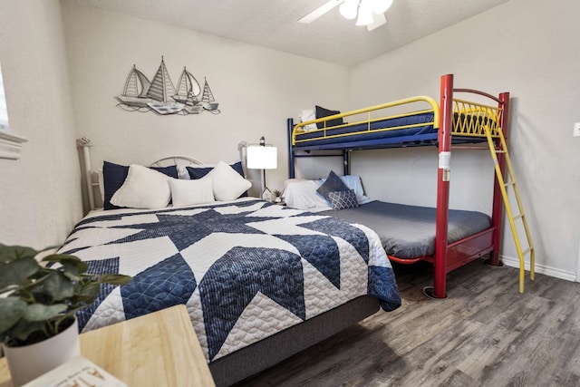 bedroom featuring ceiling fan, hardwood / wood-style flooring, and a textured ceiling