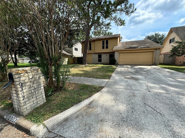 view of front of house with a front yard and a garage