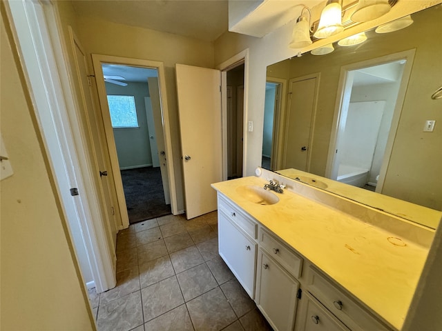 bathroom with tile patterned flooring, vanity, and toilet