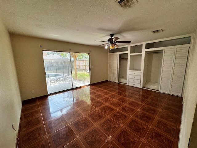 unfurnished bedroom featuring a textured ceiling, access to outside, and ceiling fan