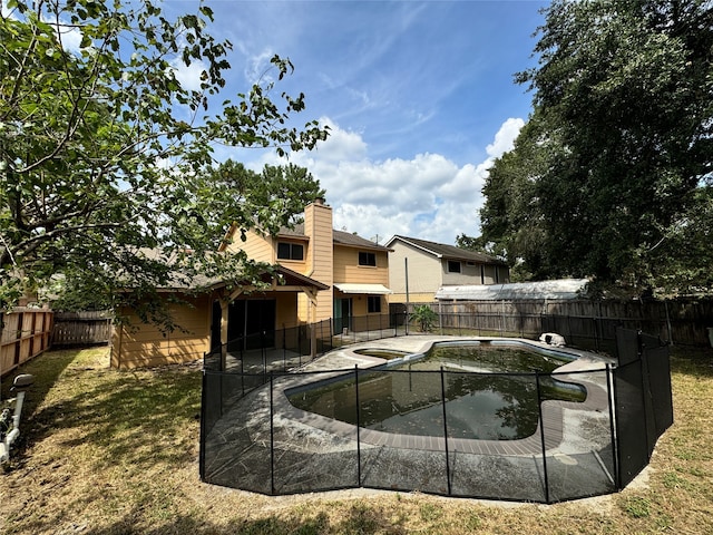 view of pool featuring a yard