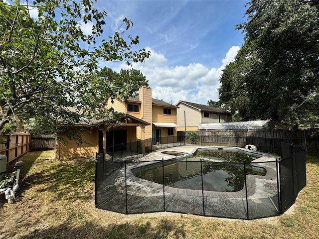 view of swimming pool with a yard