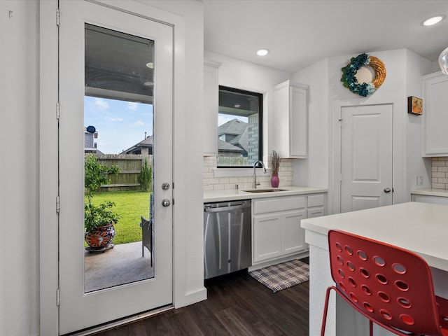 kitchen with dishwasher, a wealth of natural light, and white cabinetry