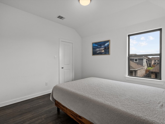 bedroom featuring dark hardwood / wood-style floors and vaulted ceiling