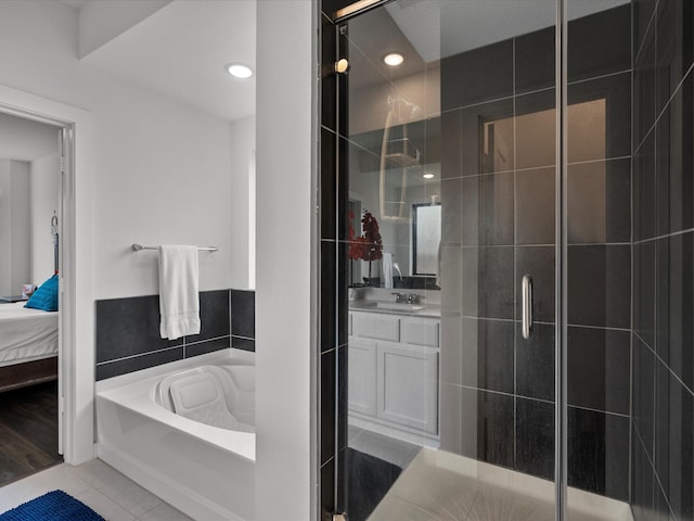 bathroom featuring vanity, tile patterned flooring, and shower with separate bathtub