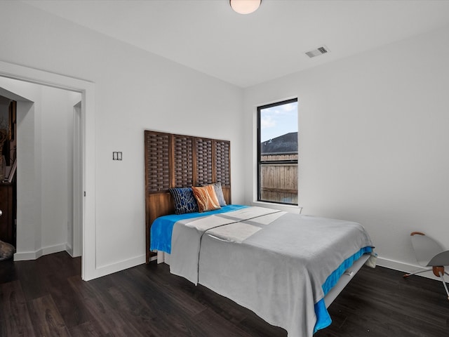 bedroom with dark hardwood / wood-style flooring