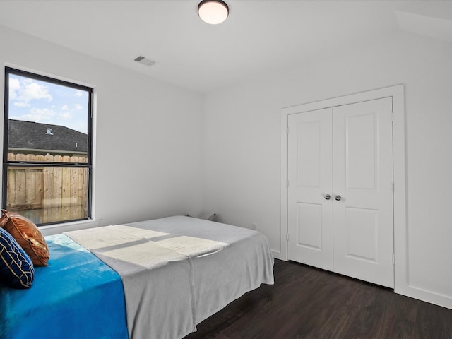 bedroom with a closet and dark hardwood / wood-style floors