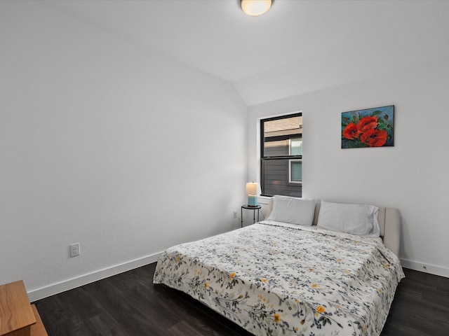 bedroom featuring dark wood-type flooring and lofted ceiling