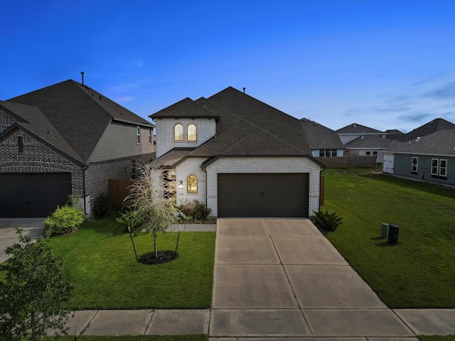 french country home featuring a garage and a front yard