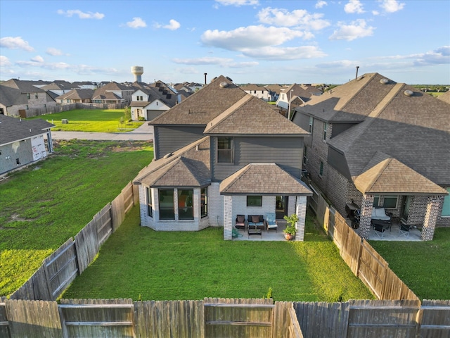 exterior space featuring a front lawn and a patio