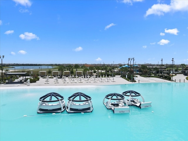 view of pool featuring a water view