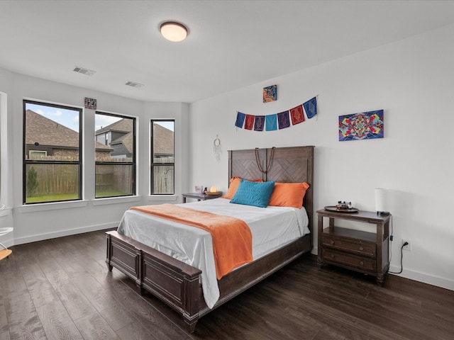 bedroom with dark hardwood / wood-style floors