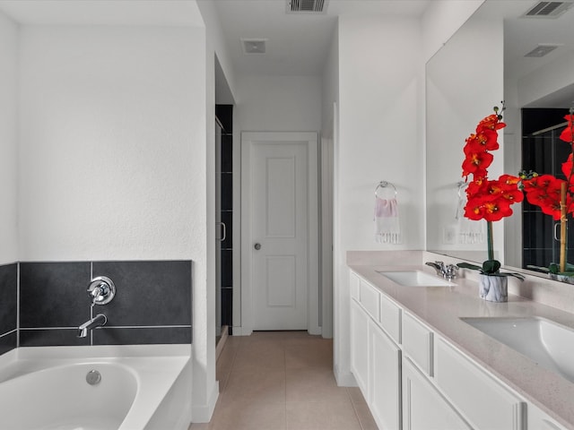 bathroom featuring tile patterned flooring, vanity, and independent shower and bath