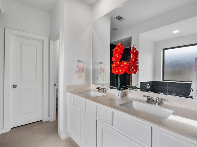 bathroom with vanity, tile patterned flooring, and toilet