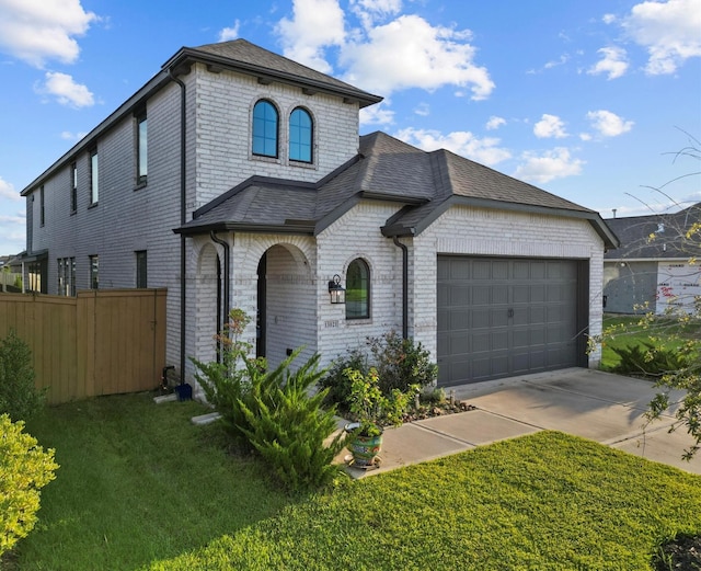 view of front of house featuring a garage and a front yard