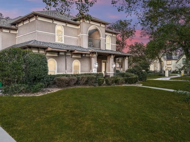 15 Bees Creek Ct, Missouri City, TX 77459 - mediterranean / spanish-style home with stucco siding, a yard, and a balcony