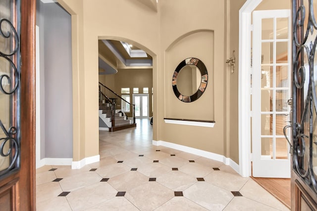 15 Bees Creek Ct, Missouri City, TX 77459 - foyer entrance with arched walkways, baseboards, stairs, and light tile patterned floors