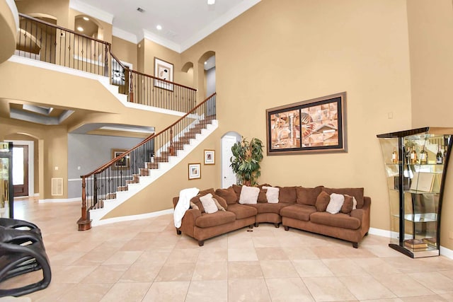 tiled living room featuring crown molding and a towering ceiling