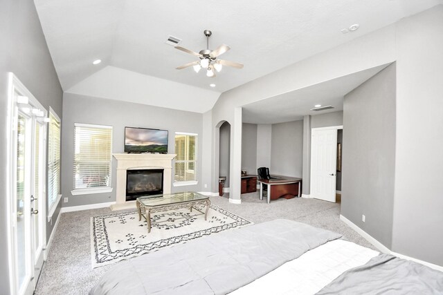 15 Bees Creek Ct, Missouri City, TX 77459 - bedroom featuring arched walkways, lofted ceiling, carpet floors, baseboards, and a glass covered fireplace