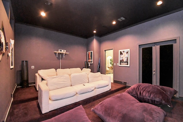 carpeted home theater featuring french doors