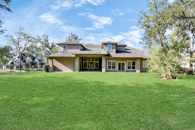 15 Bees Creek Ct, Missouri City, TX 77459 - rear view of house featuring a lawn, stucco siding, and roof with shingles