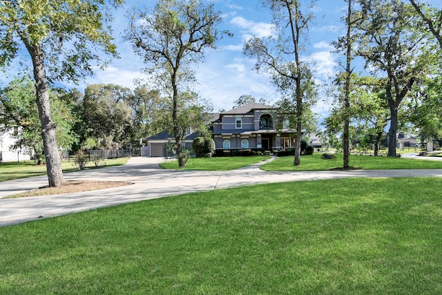 view of front of home with a front lawn and a garage