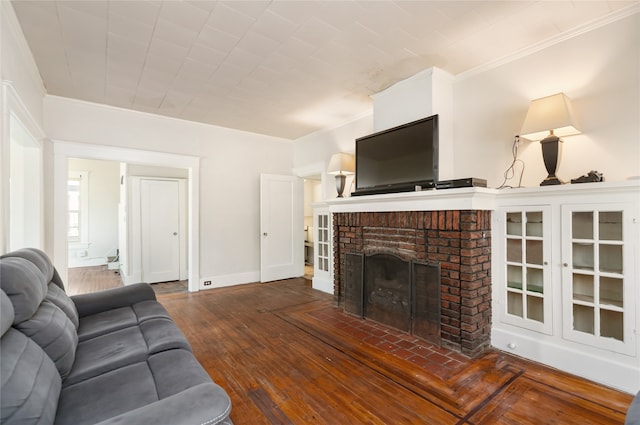 living room with crown molding, a fireplace, and dark hardwood / wood-style flooring