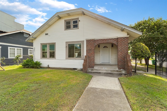 bungalow-style home with a front lawn