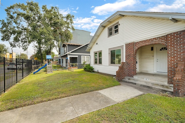 exterior space featuring a playground and a front yard