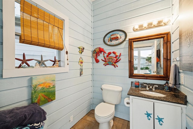 bathroom featuring vanity, tile patterned floors, and toilet