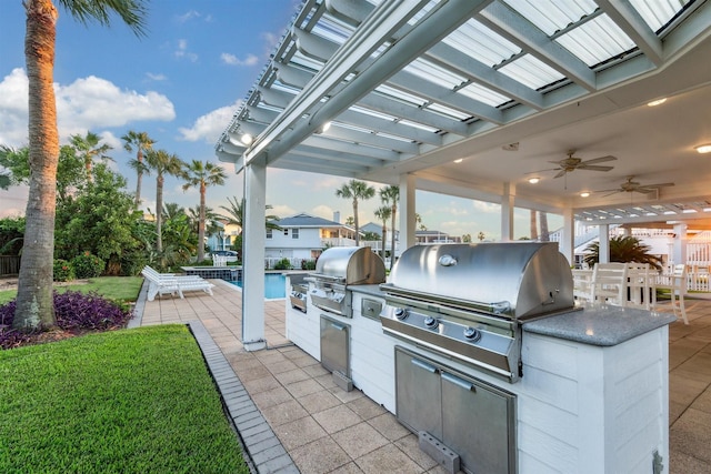 view of patio featuring an outdoor kitchen, area for grilling, and ceiling fan