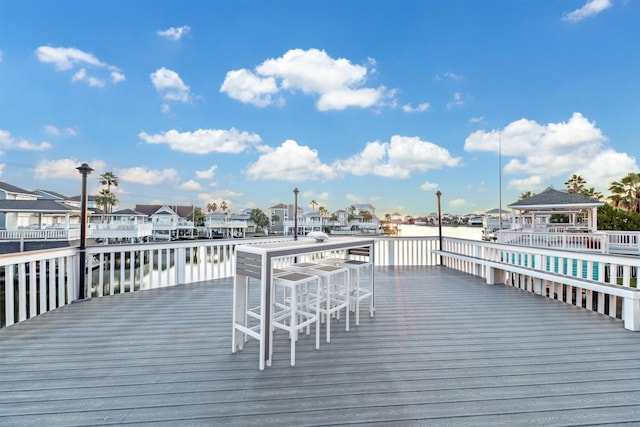 view of dock featuring a gazebo and a water view