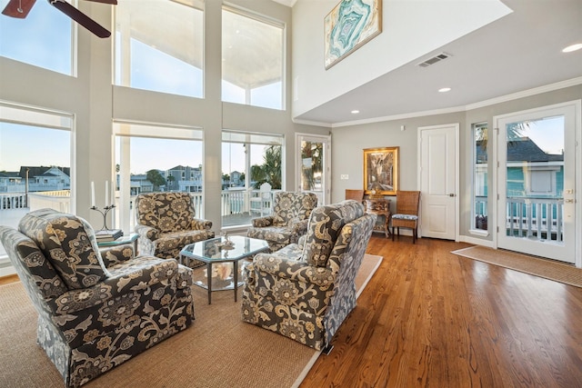 living room featuring hardwood / wood-style flooring and ornamental molding