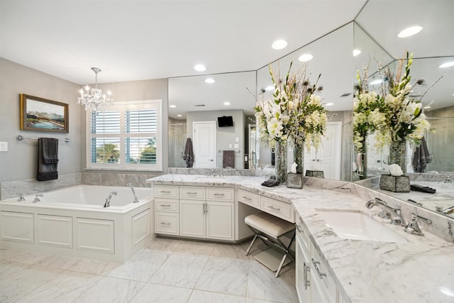 bathroom with an inviting chandelier, vanity, and shower with separate bathtub