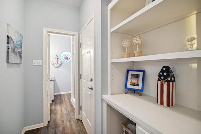 hallway with dark hardwood / wood-style flooring