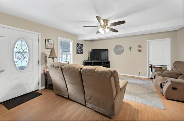 living room featuring ceiling fan and light hardwood / wood-style flooring