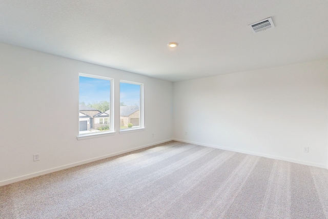 empty room featuring light carpet