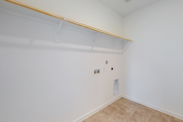 washroom featuring washer hookup, light tile patterned floors, and electric dryer hookup