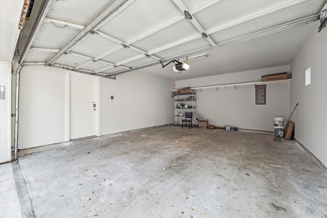 garage with a garage door opener and electric panel