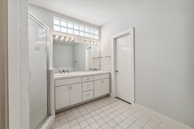 bathroom with vanity, a shower with door, and tile patterned floors