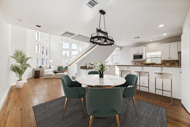 dining area with ceiling fan and light hardwood / wood-style floors