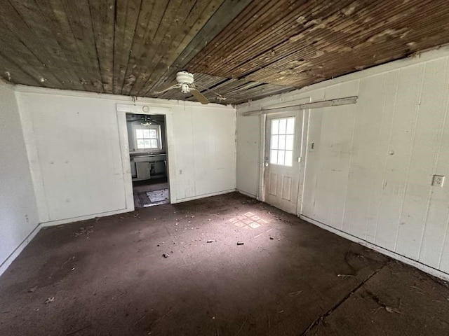 interior space with wood ceiling, ceiling fan, and plenty of natural light