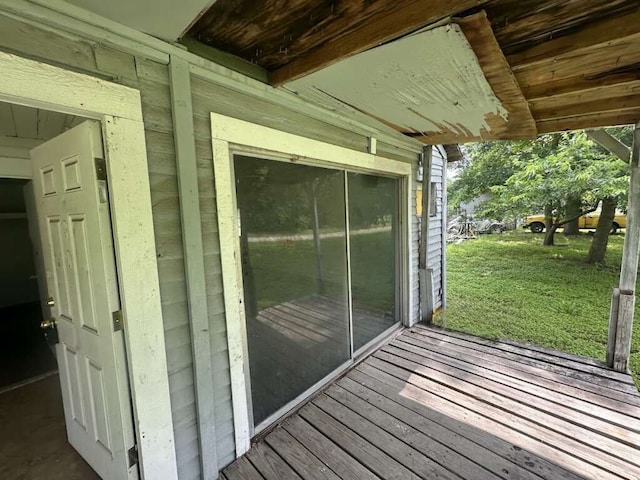 wooden terrace featuring a yard