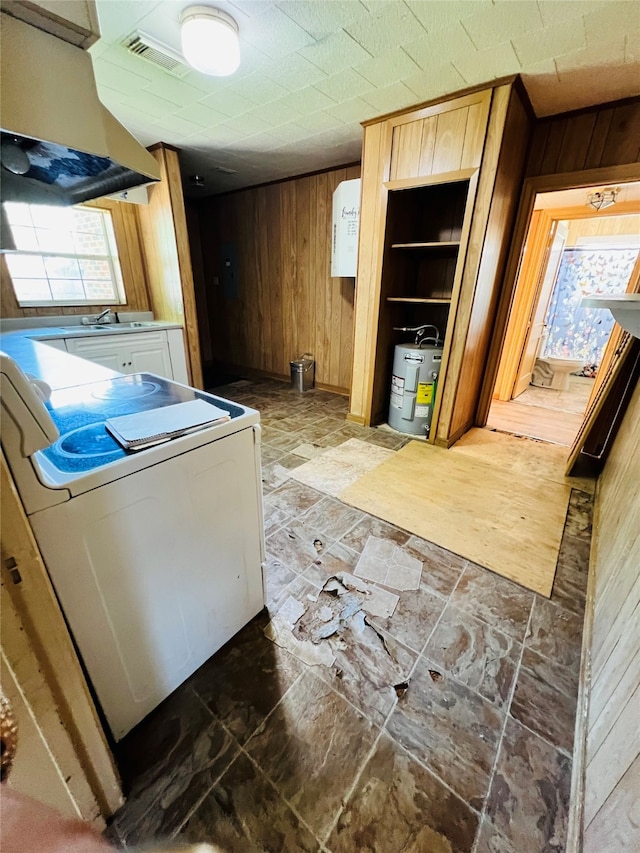 clothes washing area featuring washer / dryer and wooden walls