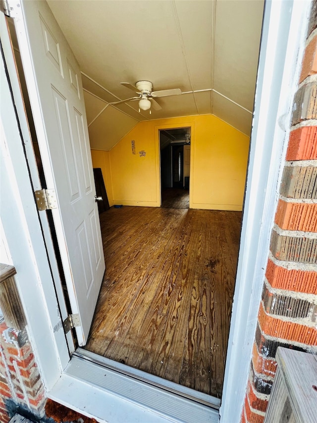 bonus room with vaulted ceiling, ceiling fan, and dark hardwood / wood-style flooring