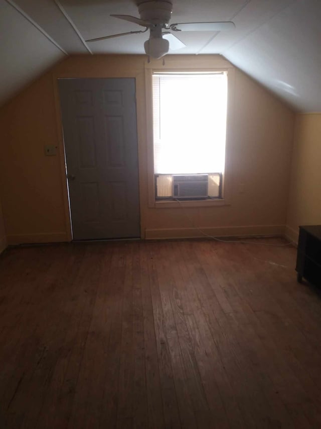 additional living space with dark wood-type flooring, ceiling fan, cooling unit, and vaulted ceiling