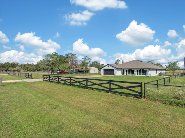 view of yard featuring a rural view and a garage