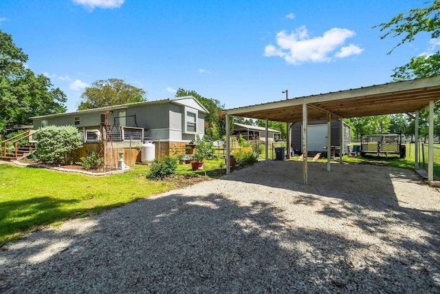 view of front of property with a front yard and a shed