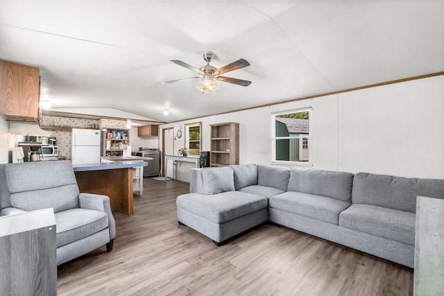 living room with lofted ceiling, ceiling fan, and light wood-type flooring