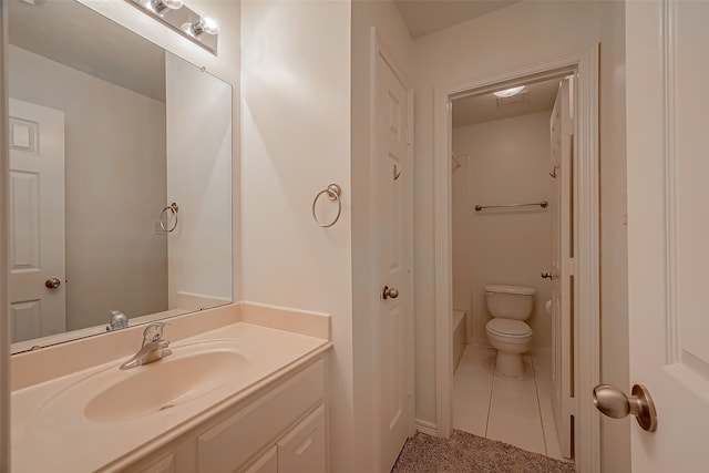 bathroom featuring tile patterned flooring, vanity, and toilet